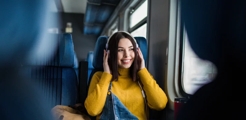 girl on train listening to music